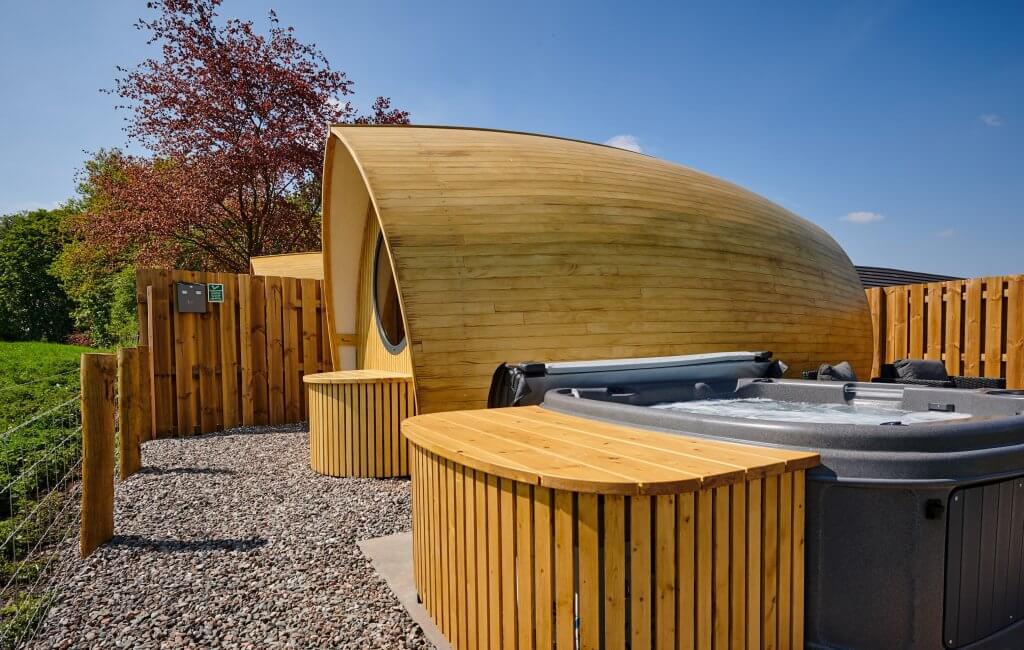 Luxurious Glamping Pods with Hot Tub Attached in Scenic Location.